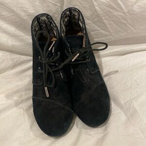 Black suede Tom’s wedge heel booties.